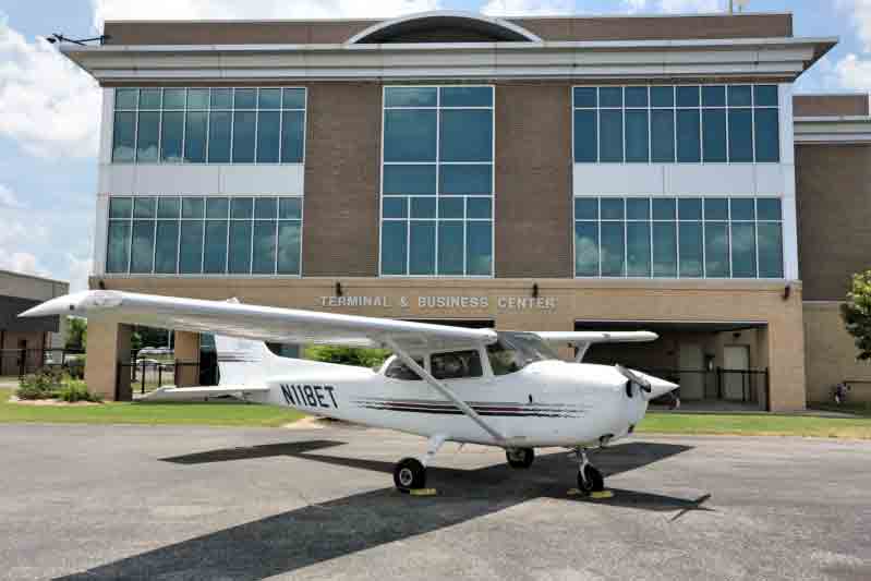 Copy of N118ET Plane parked in front of building complex