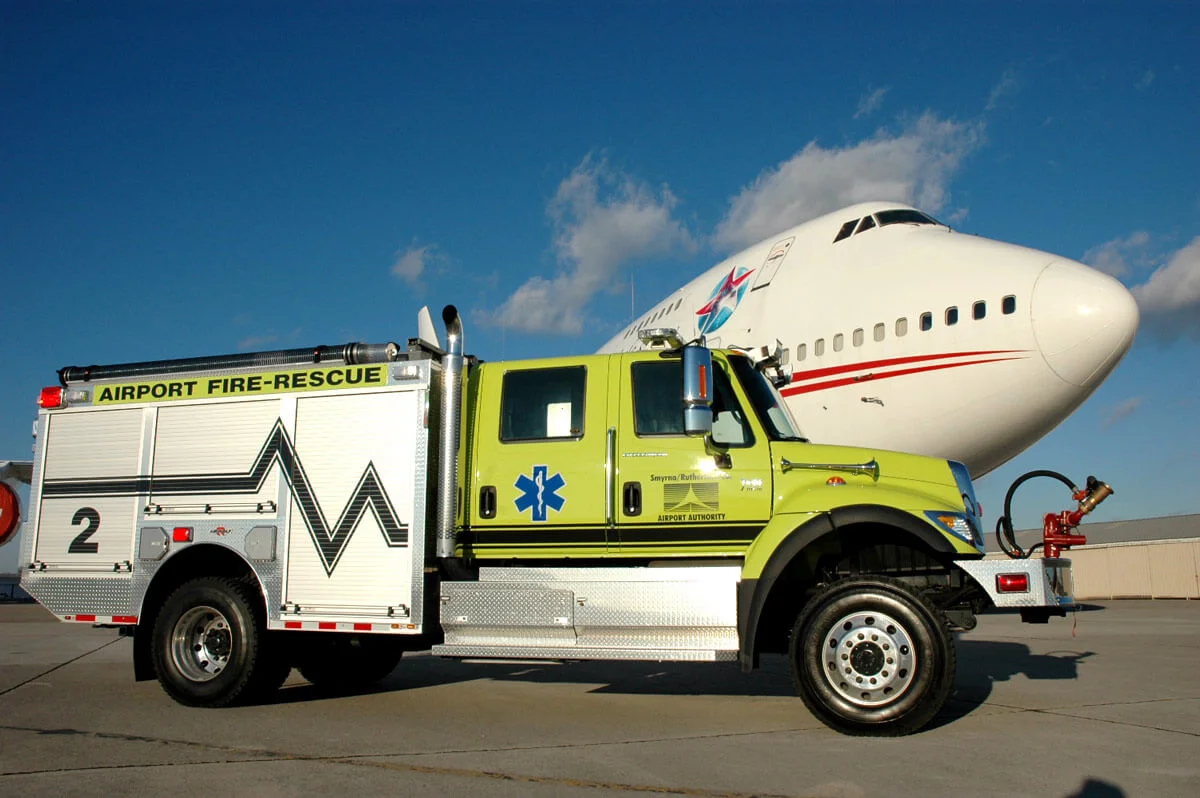 F2 emergency vehicle parked in front of a 747 Jet