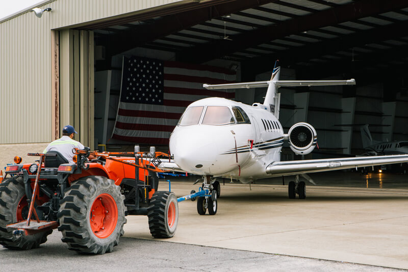 Contour airplane being pulled from a hangar by a tractor - Smyrna / Rutherford Country Airport Authority