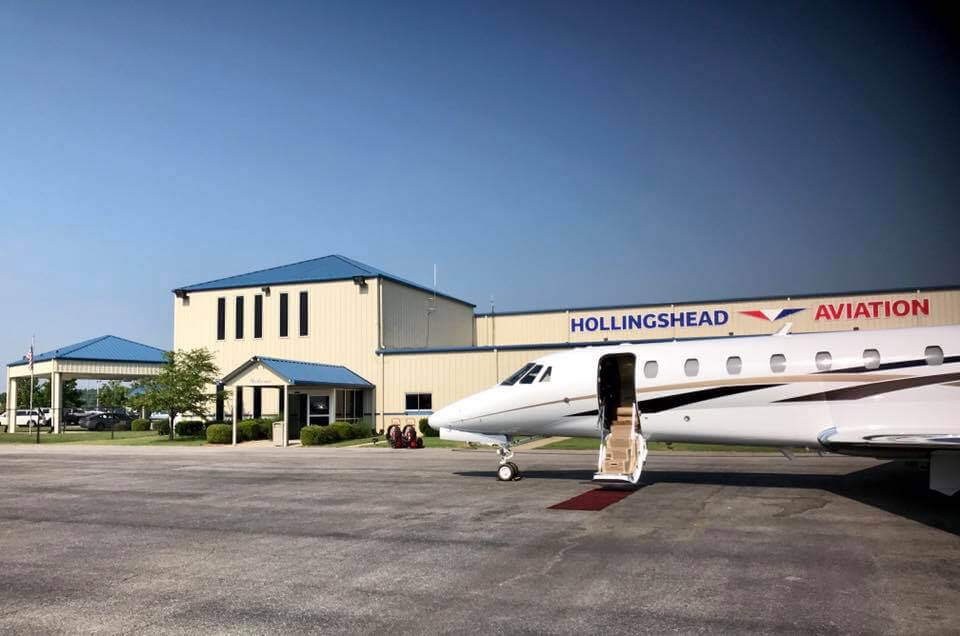 Small passenger jet parked in front of Hollingshead Aviation Building- Smyrna / Rutherford Country Airport Authority
