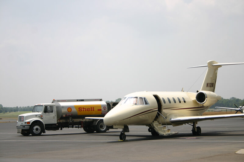 Refueling truck parked next to small passenger jet - Smyrna / Rutherford County Airport Authority