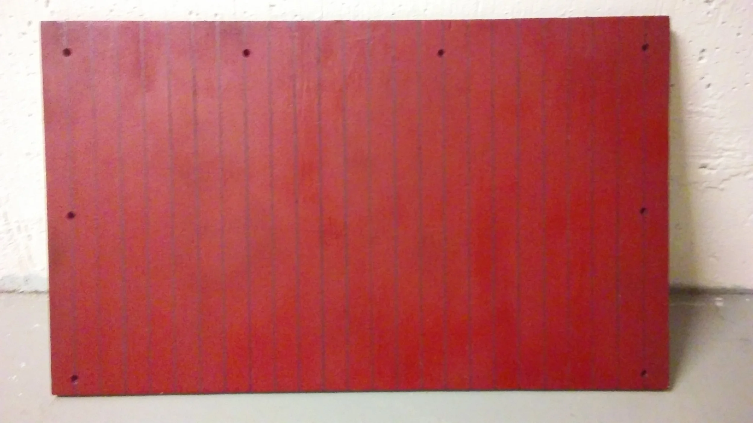 Result of the stencil plus a light spray of the lighter red to even the color out a bit. Will use darker red when dry to paint in some details to create a weathered effect. Windows have been covered up but have the measurements written down to paint them back in once the boards are finished.