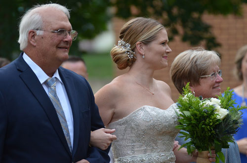 Bride Carla chose simple diamond earrings and a lightweight single-diamond necklace for her summer wedding. The Flaherty-Miller Wedding, bridebook 2019, page 40. Image by KK Images.