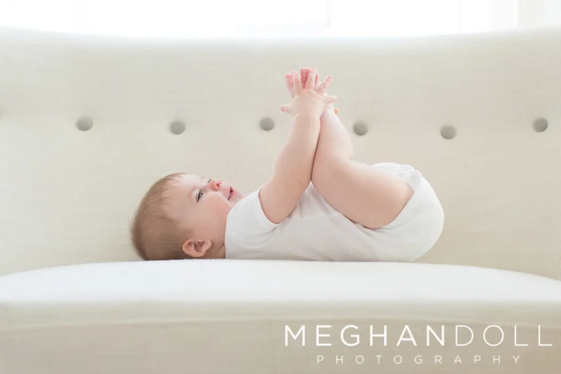 six-month-old-boy-plays-with-his-toes