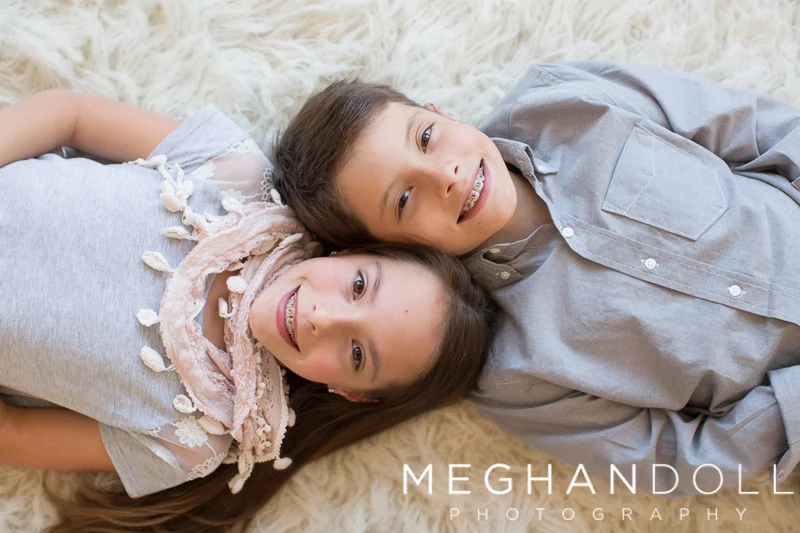 twin-brother-and-sister-lay-on-rug