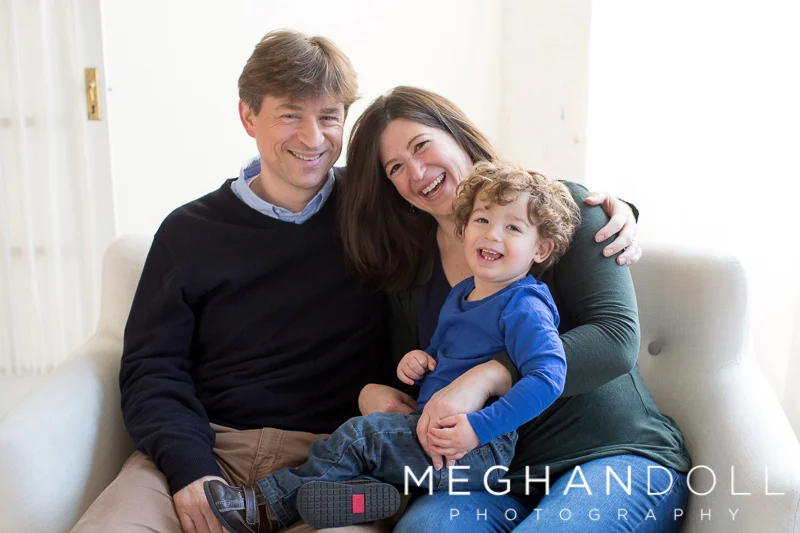 mom-and-dad-snuggle-two-year-old-son-on-couch
