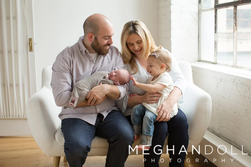 family-interacts-with-new-baby-boy