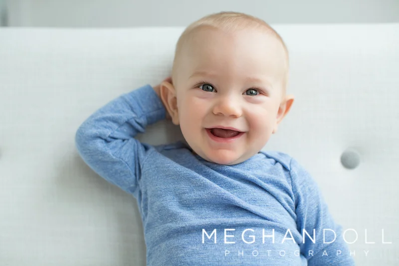 six-month-old-baby-boy-poses-on-couch