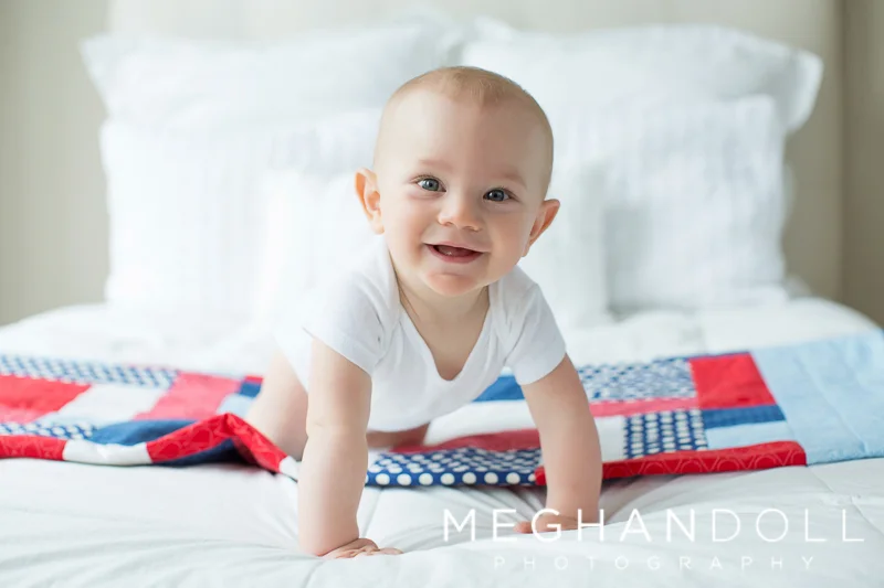 six-month-old-boy-plays-on-quilt