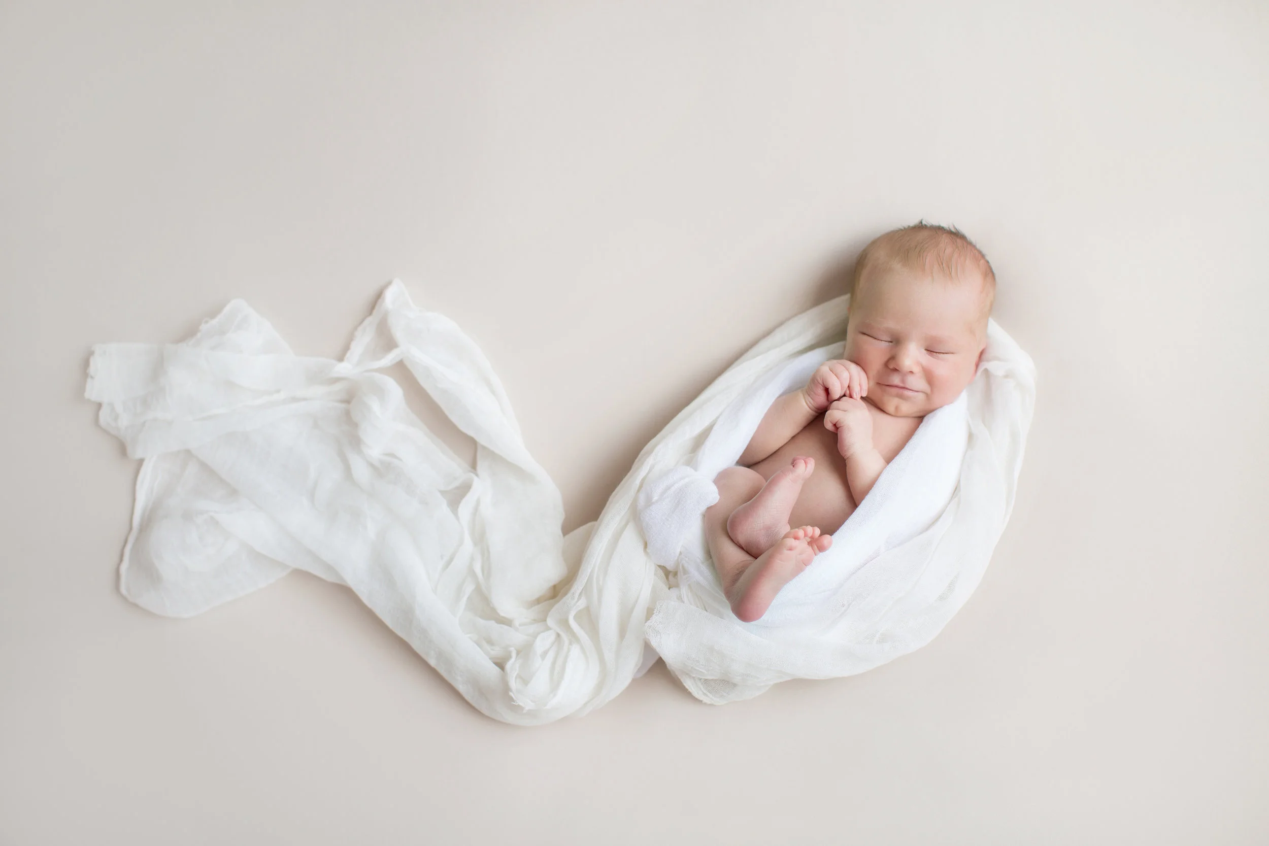 newborn_baby_wrapped_in_white.jpg