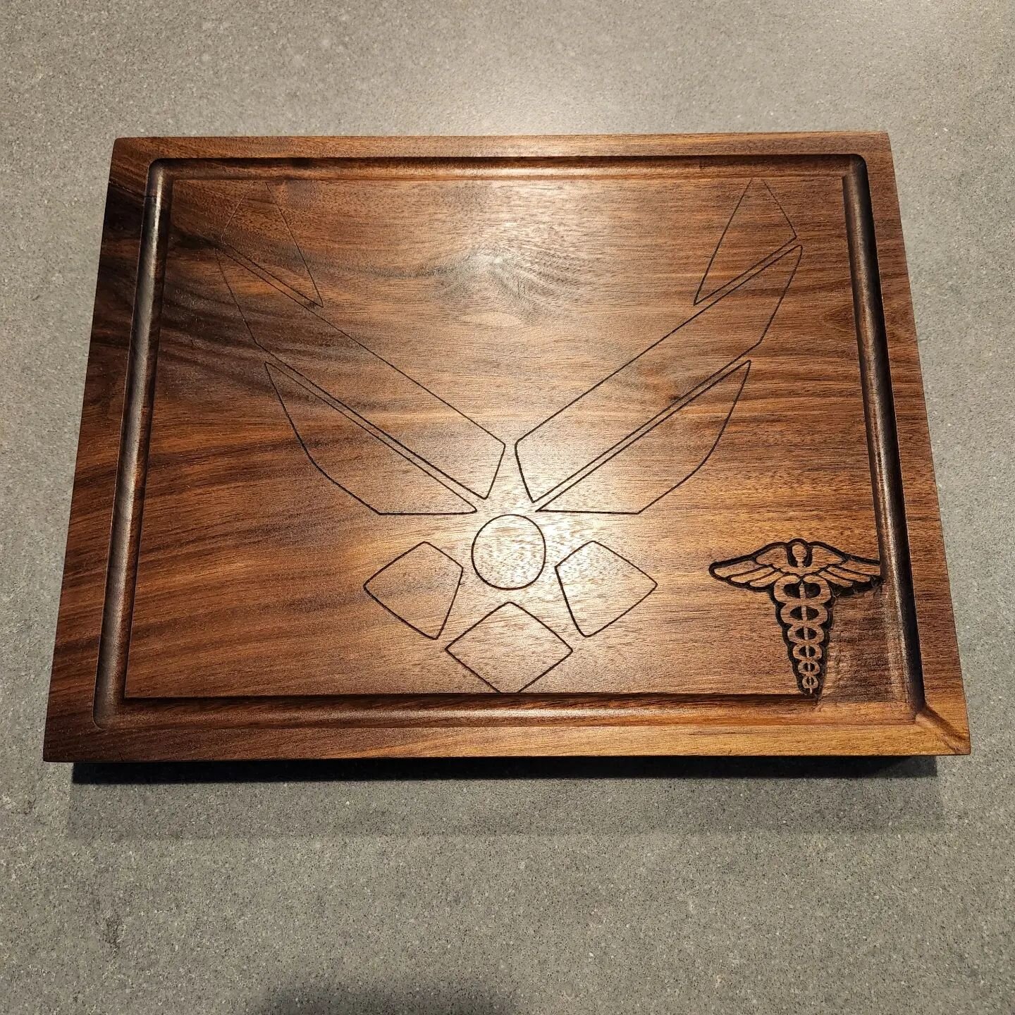 Had the honor of making this 2&quot; thick black walnut cutting board with juice groove and pour spout for @grubmaster52 son. Engraved with the Air Force emblem centered on the board and a combat medic emblem in the blood pool.

#airforce #combatmedi