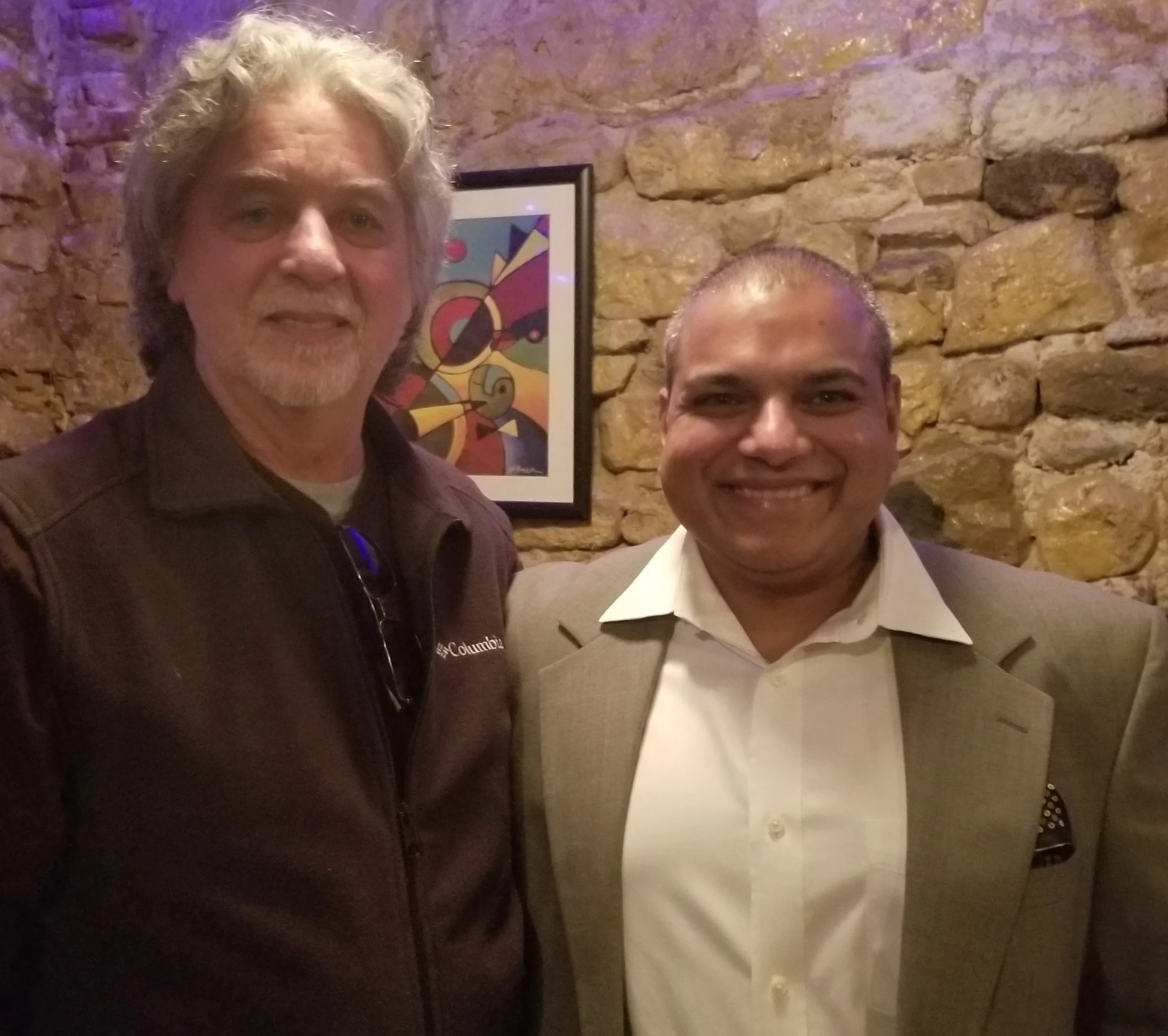 Yogesh and dean celebrate together at a holiday party