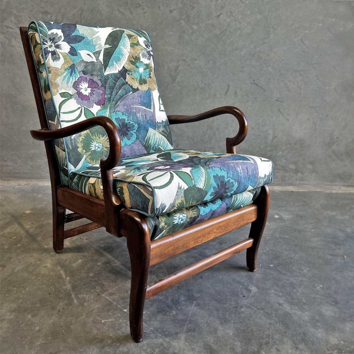 Curvaceous TV chair reupholstered in a floral print
