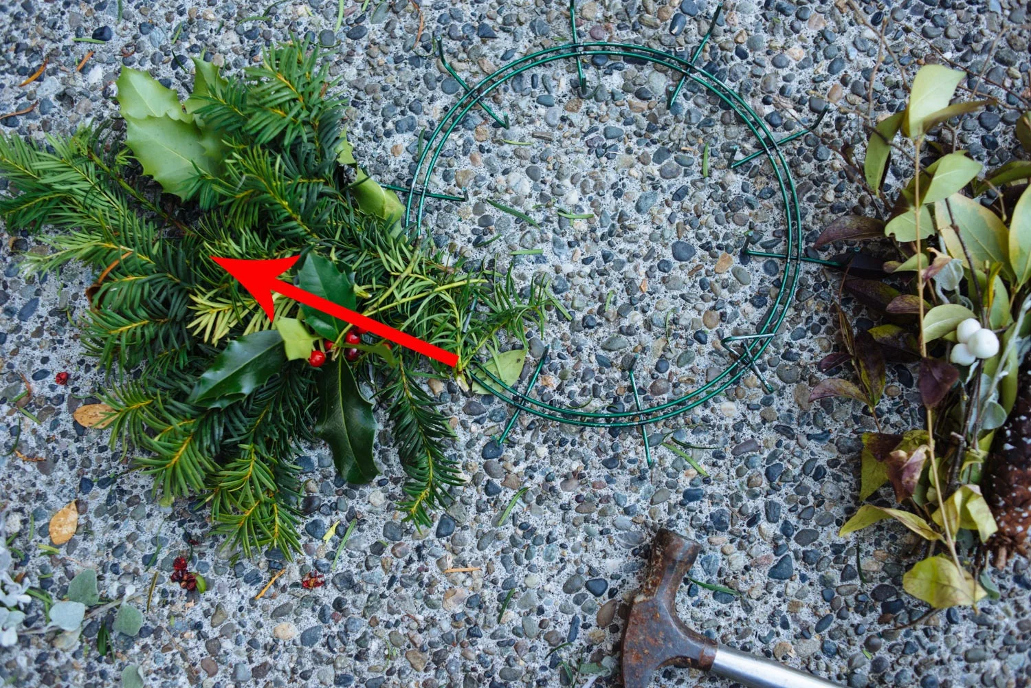 Lay bouquet 1 diagonally facing outward from the frame. Hammer down the spikes to hold it in place.