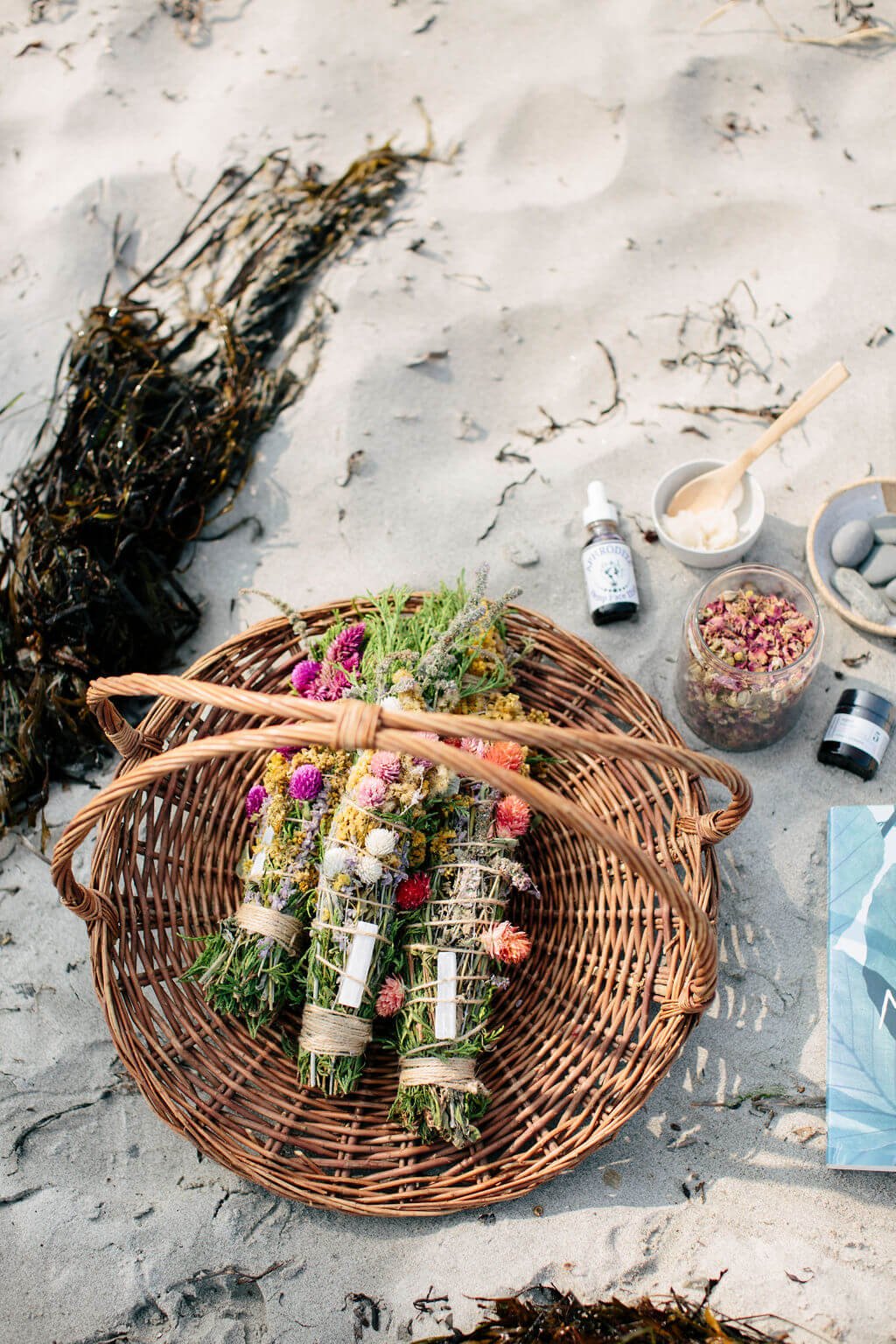 flowers and holistic wellness products on beach.jpg