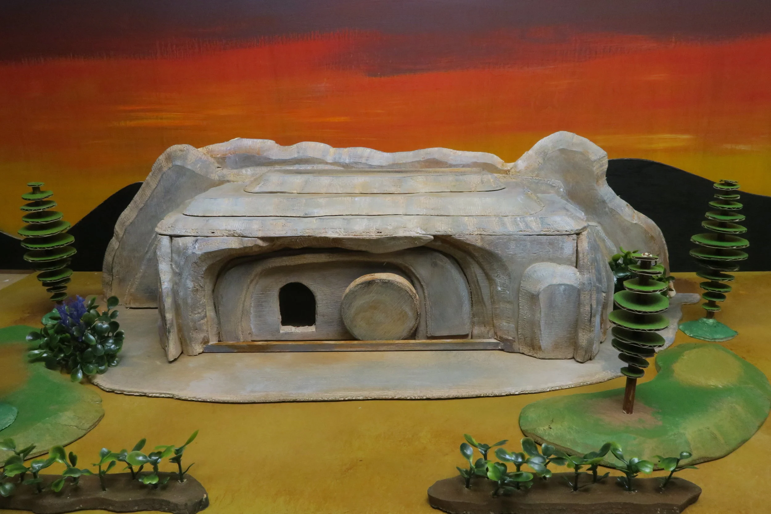   SLIDE 9  On Good Friday night Jesus’ dead body was taken off the cross and buried in the tomb of a man named Joseph of Arimathea . The tomb had been cut out of stone and looked very much like a cave. 