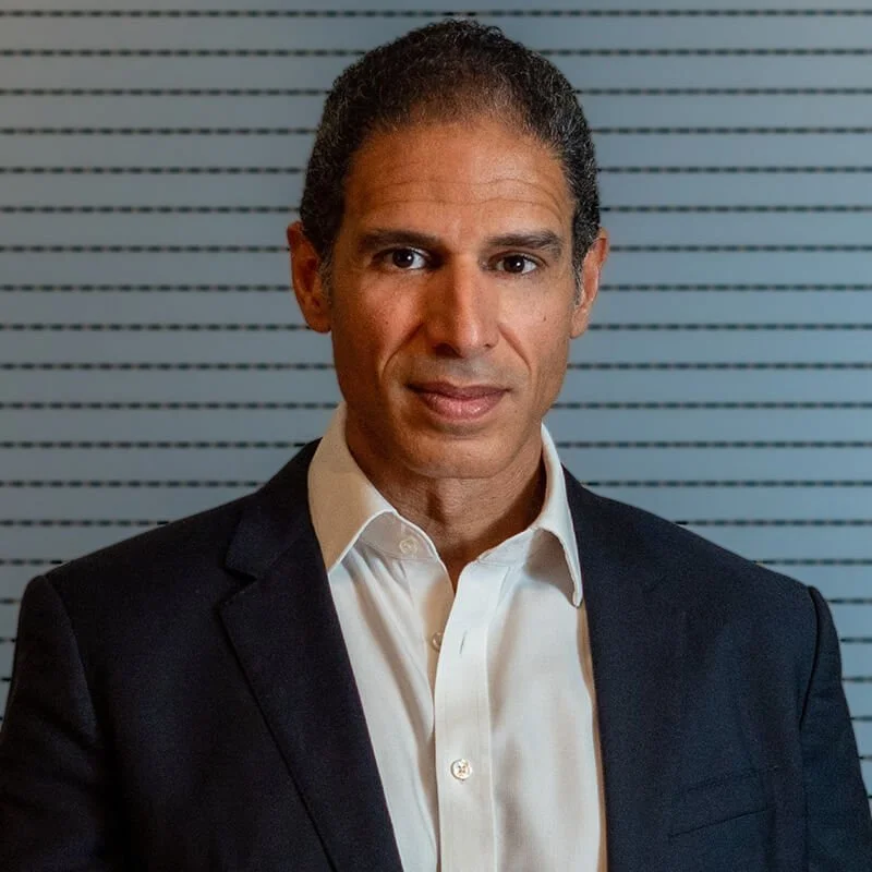 portrait of Mohamed Amar in white shirt and blue jacket