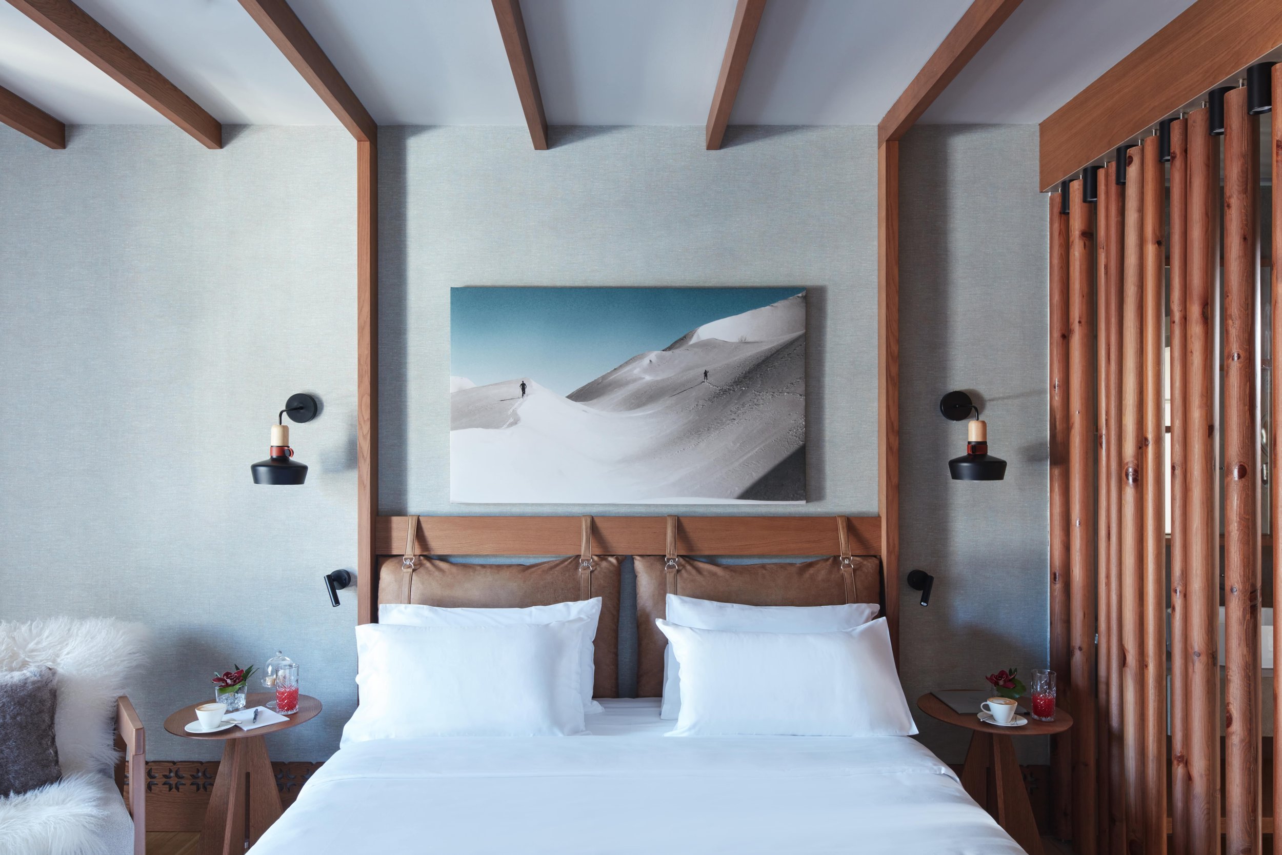 Grand hotel Savoia bed with a canvas of mountains covered in snow above bed frame 
