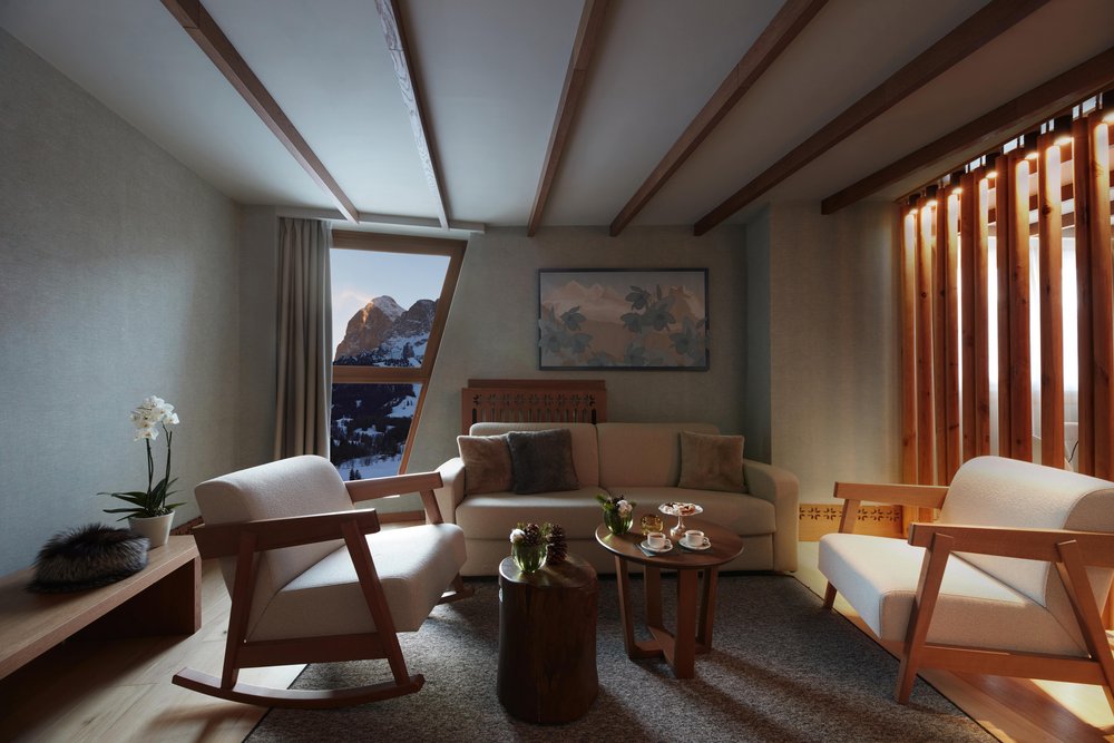 A suite lounge area with sofas and coffee table infant of a window with Mountain View