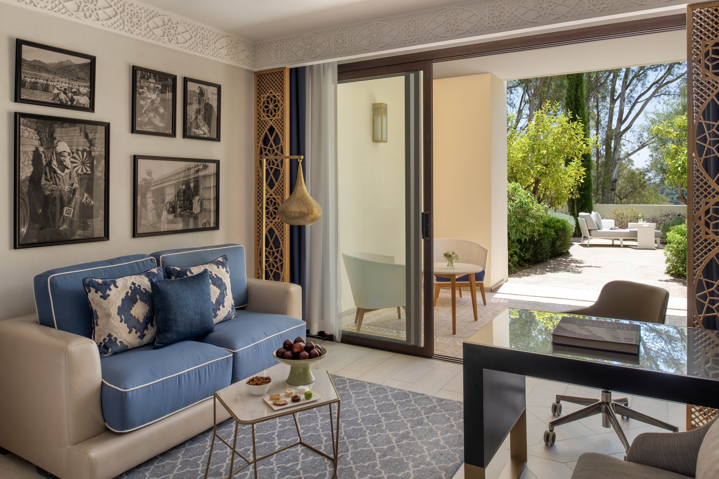 A below two seat sofa in front of a terrace entrance in one of the Fairmont Tazi Palace suites