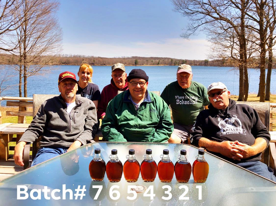 Maple Syrup 2019, 1350? gallons boiled in 7 batches. Samples from each batch are shown. The last of the season are on the left to the first of the season are on the right. The beginning is always lighter, with possible changes according to weather and temperature, affecting how fast the trees run, though always consistently graduating to a dark color by the end of the season. There was debate about the light color of batch number 5 being associated with a snow storm, and 2 seemed pretty dark for the beginning of the season, but wow does it taste GOOD. Left to right: Gary Clark, Jackie (Hakes) Brix, Bill Hakes, Dave Hakes, Jim Hakes, Les Fischer.