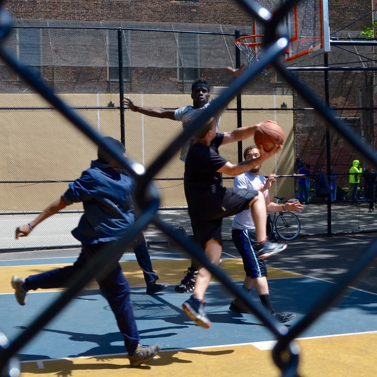 “The Cage” basketball court in the Village is half of regulation size. Because it's so compact, the streetball gets physical, fast and intense.
