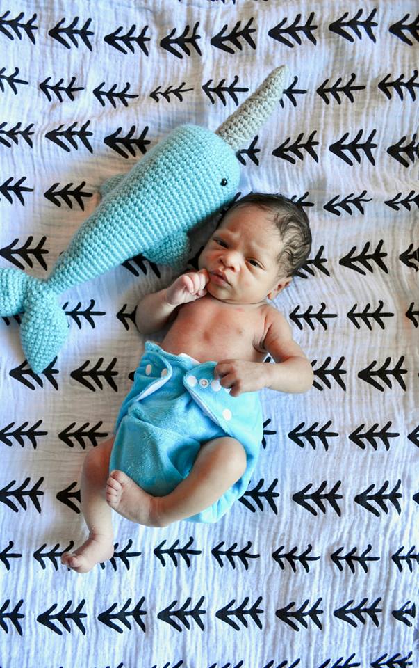 1 week old in his unofficial monthly update diaper