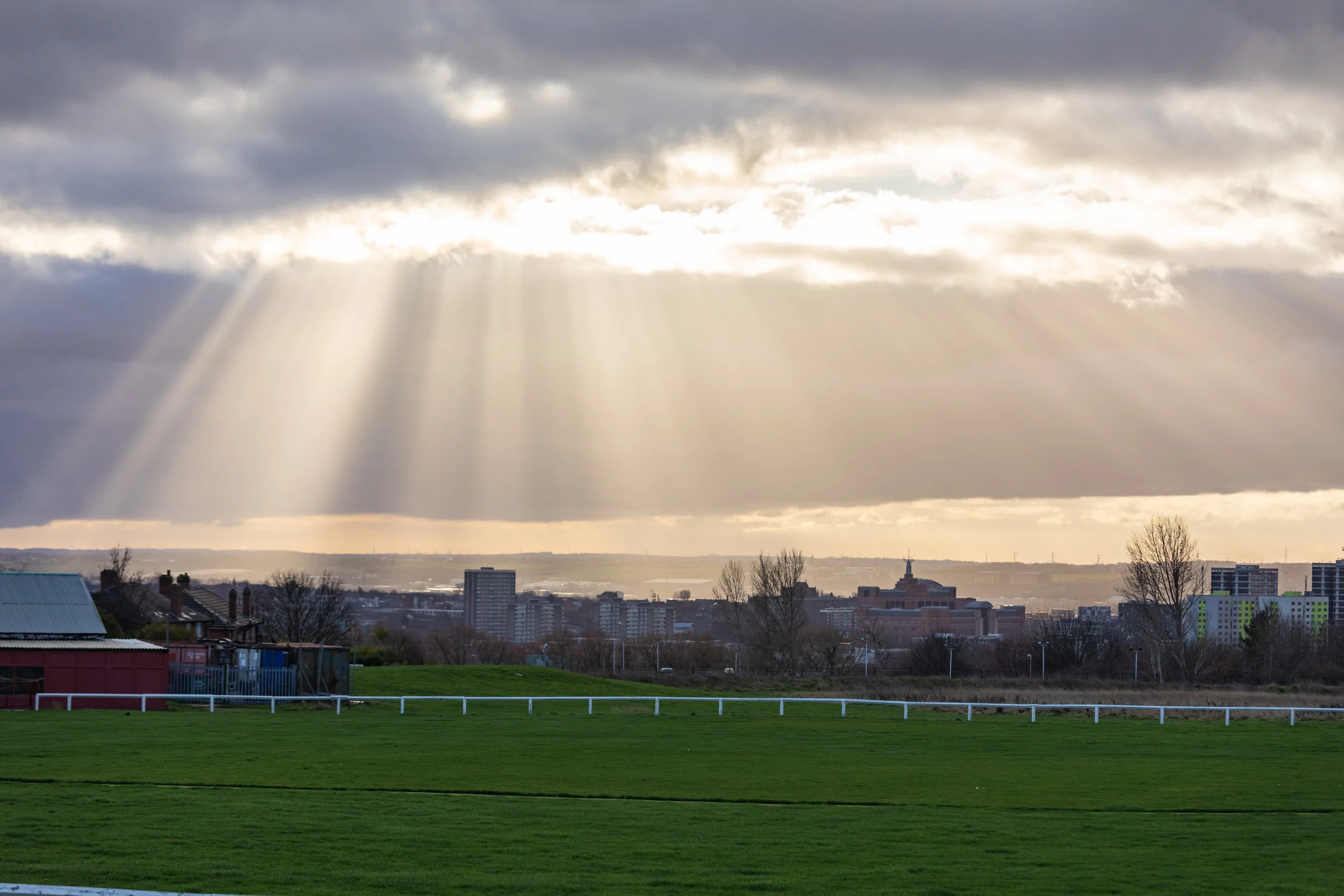 Sunlight breaking through the clouds on Scott Hall Field, Leeds