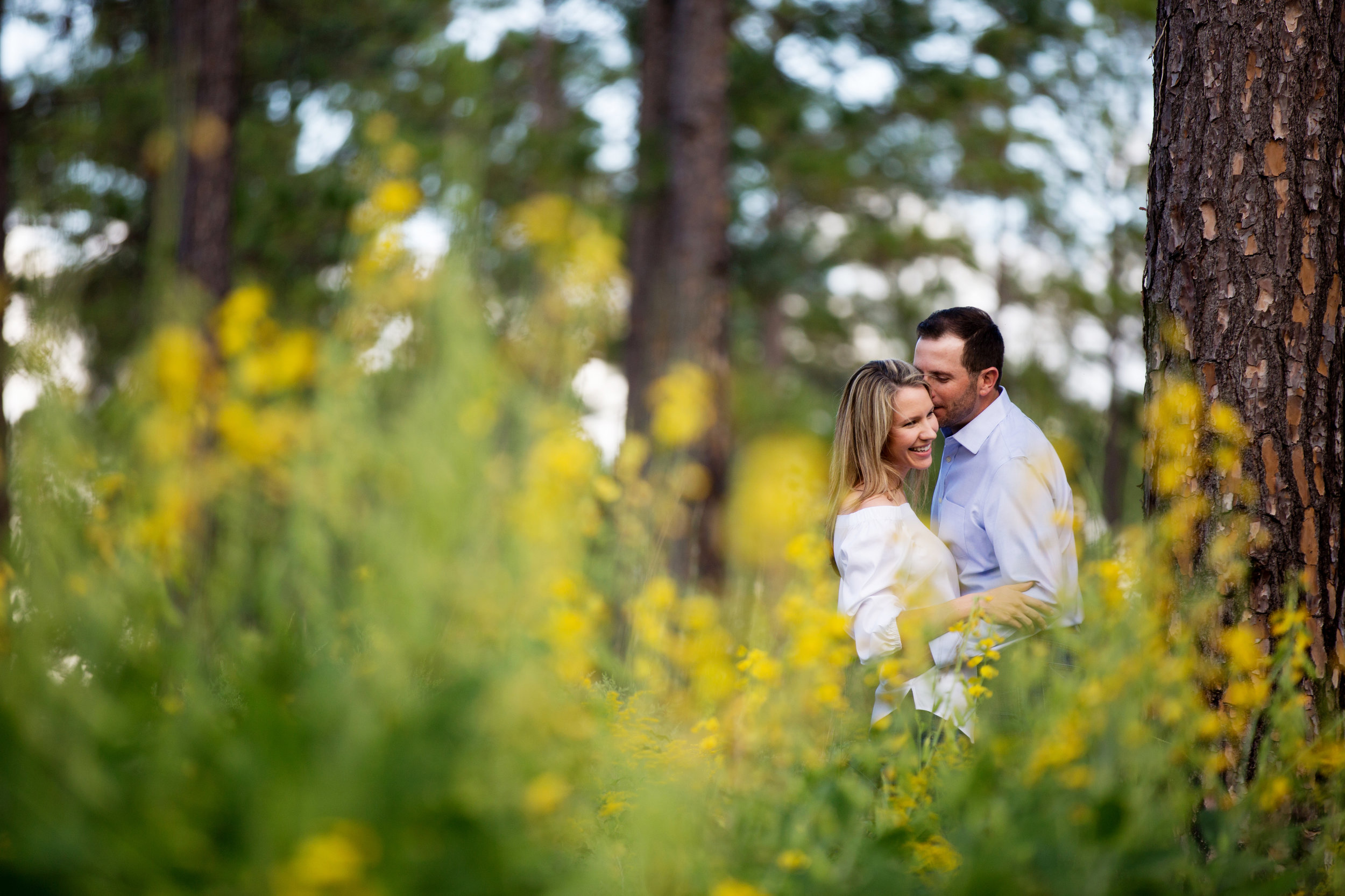 Outdoor Engagement Photography in a field with yellow flowers