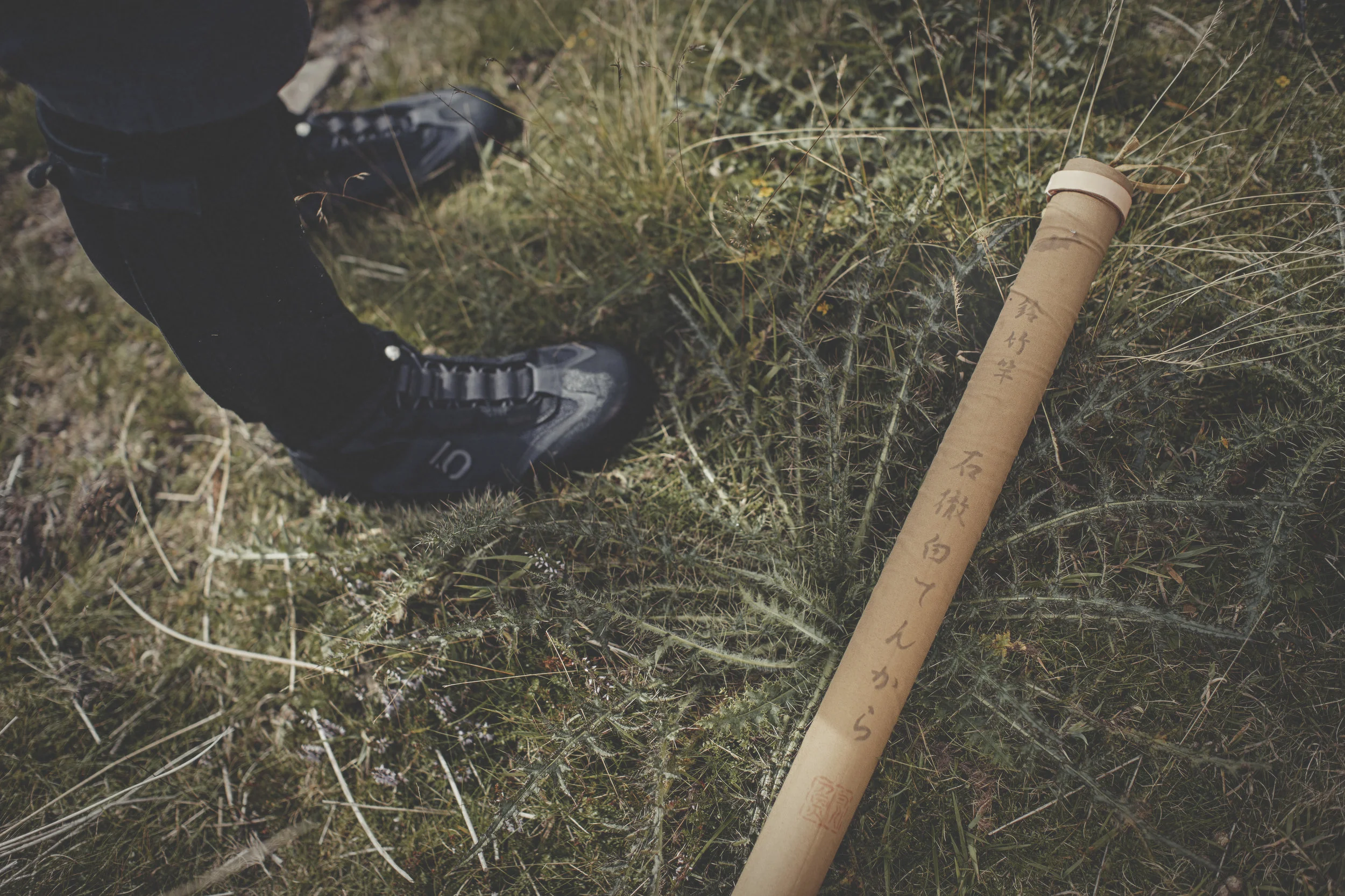 Waders are too slow to work up and down the fast stream, instead neoprene leg wraps are used. Here pictured is a traditional rod carrying case