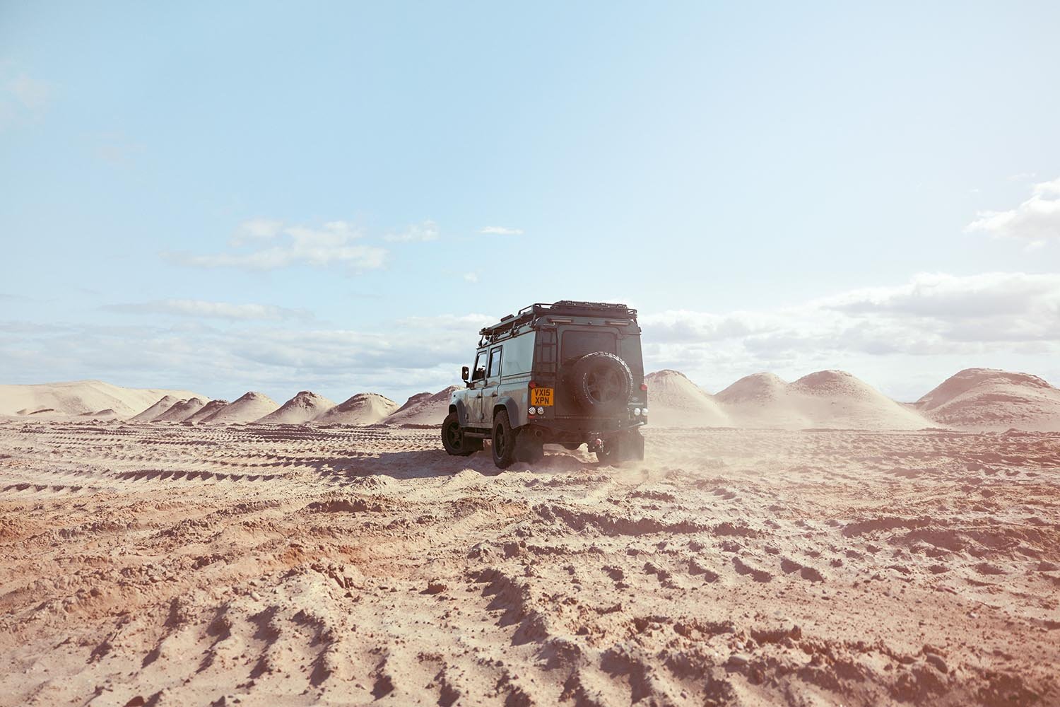 a Land Rover defender in a sand quarry by automotive photographer Matthew Lloyd