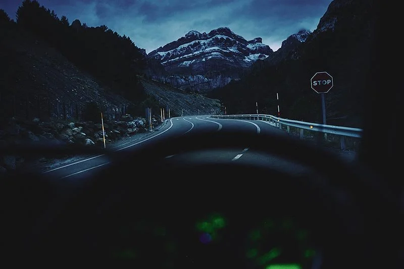 the pyrenees are seen through the windscreen of a Land Rover defender by photographer Matthew Lloyd