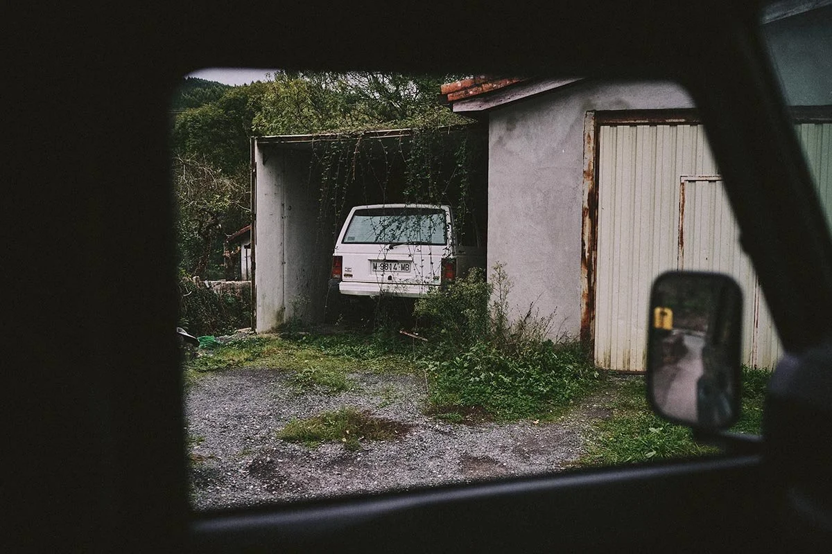 a classic 4x4 sits in an overgrown garage in this travel image by automotive photographer Matthew Lloyd