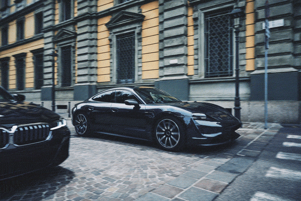 a model with a Porsche Taycan GTS in Milan