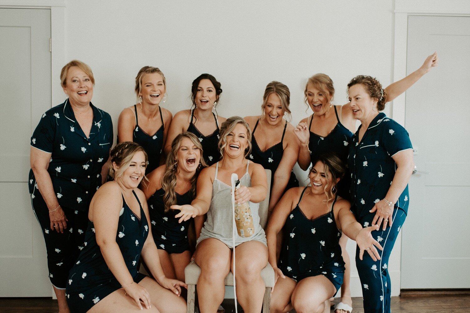 navy bridesmaids pajamas and champagne popping