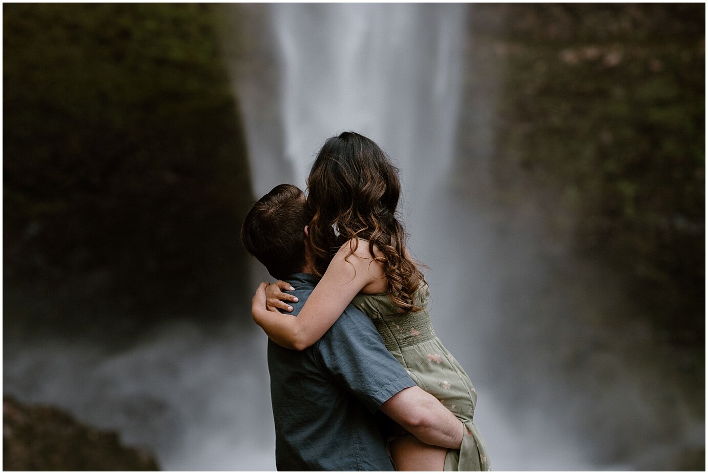 engaged couple posing in front of a waterfall in mt hood, oregon