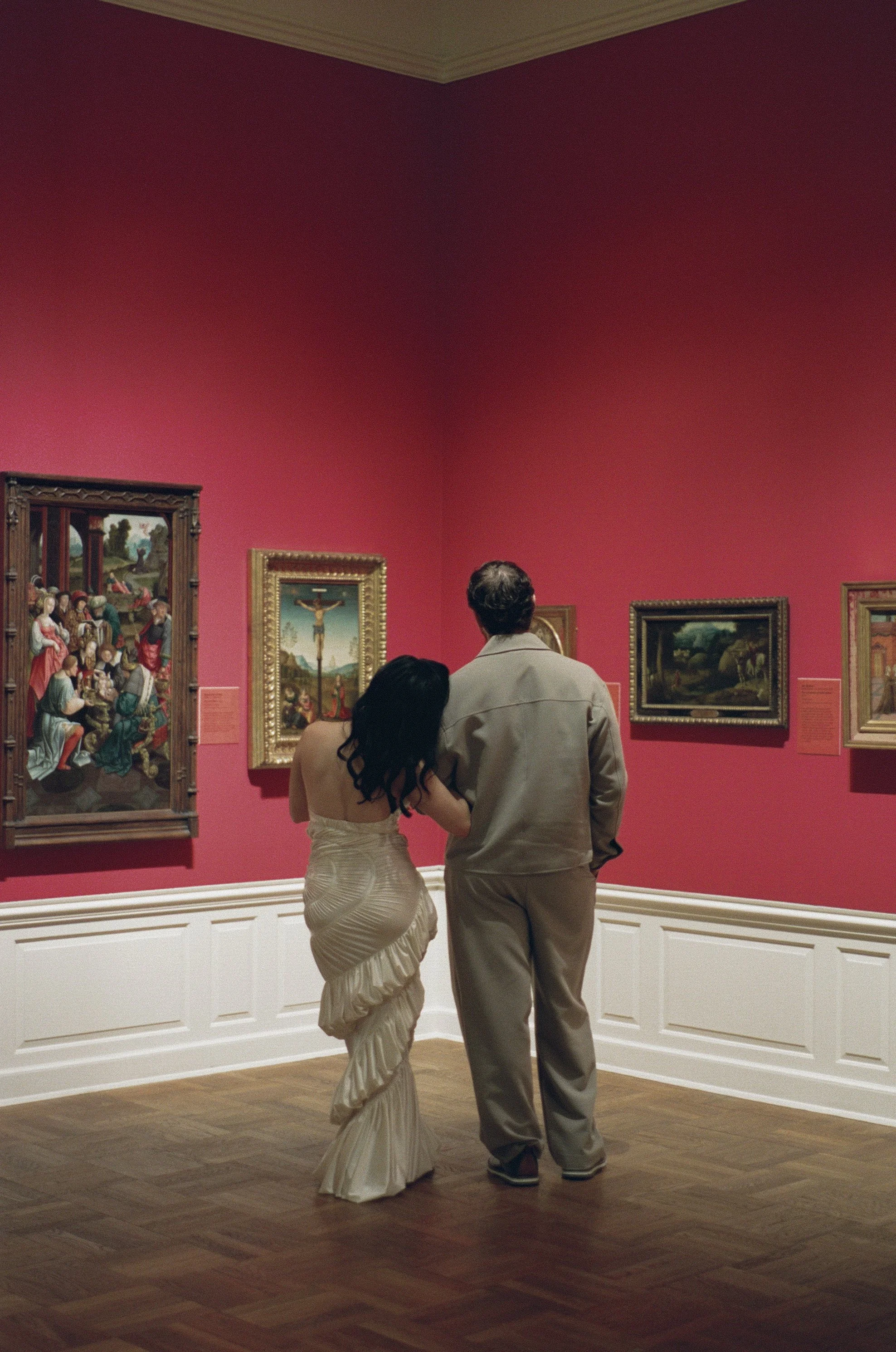 Couple sharing a quiet moment surrounded by artwork at the Portland Art Museum, documentary style engagement photography, shot on film 