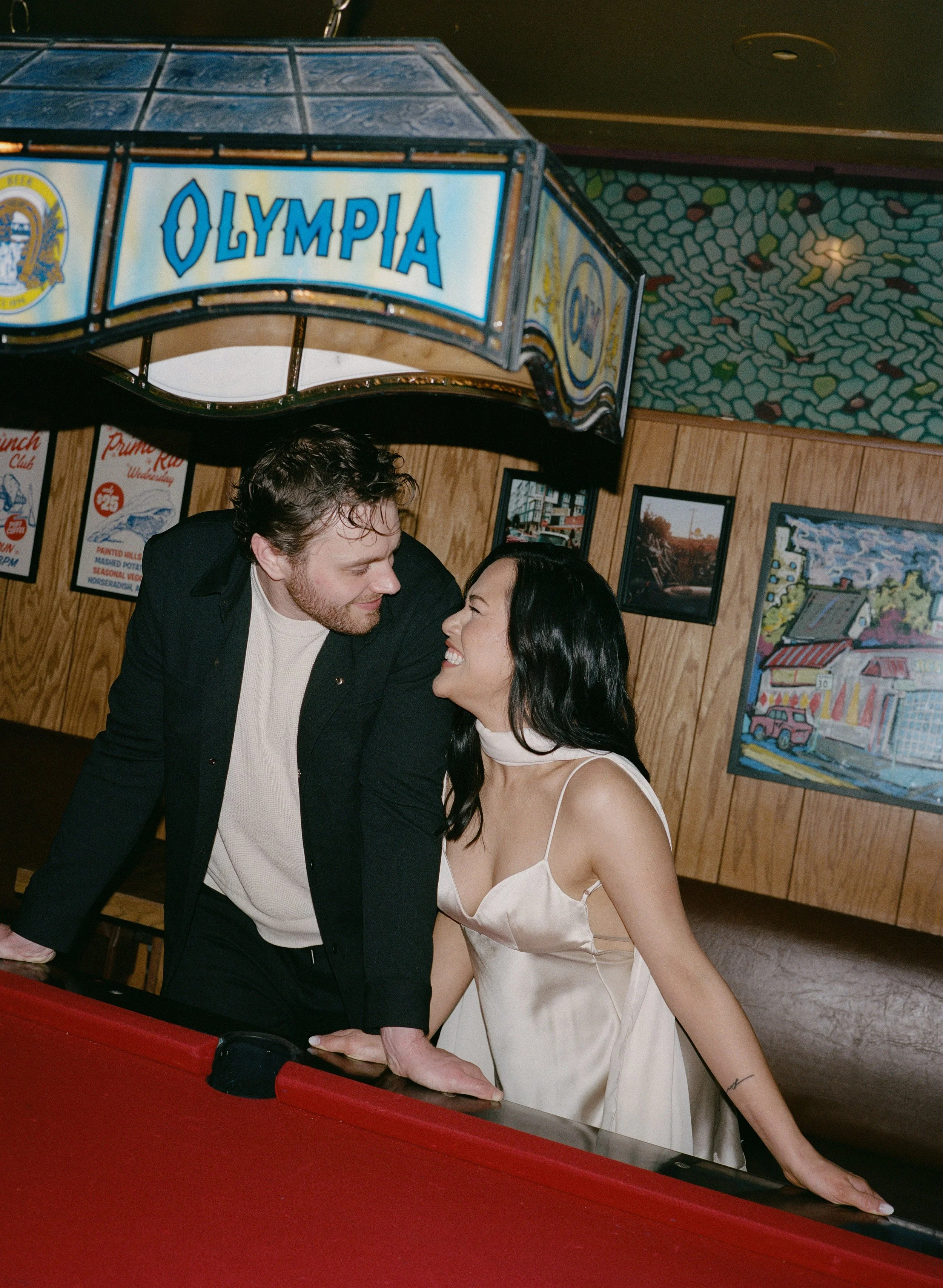  Intimate flash portrait of Rachel and Dakota inside The Sandy Hut dive bar, cozy and nostalgic Portland engagement photos, shot on 