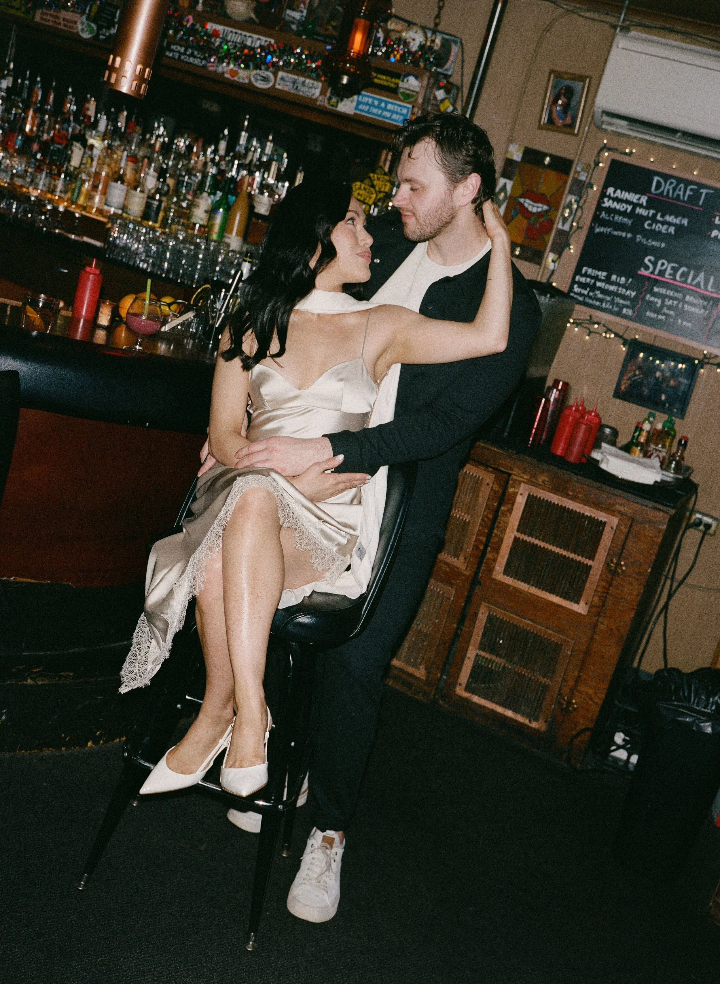  Intimate flash portrait of Rachel and Dakota inside The Sandy Hut dive bar, cozy and nostalgic Portland engagement photos, shot on 