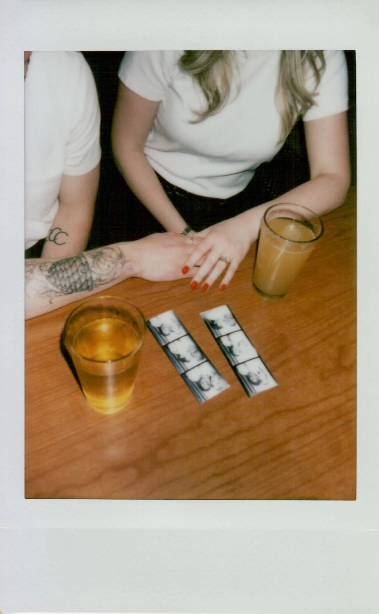  polaroid of couple during engagement session in Portland Oregon, soft tones and instant film texture 