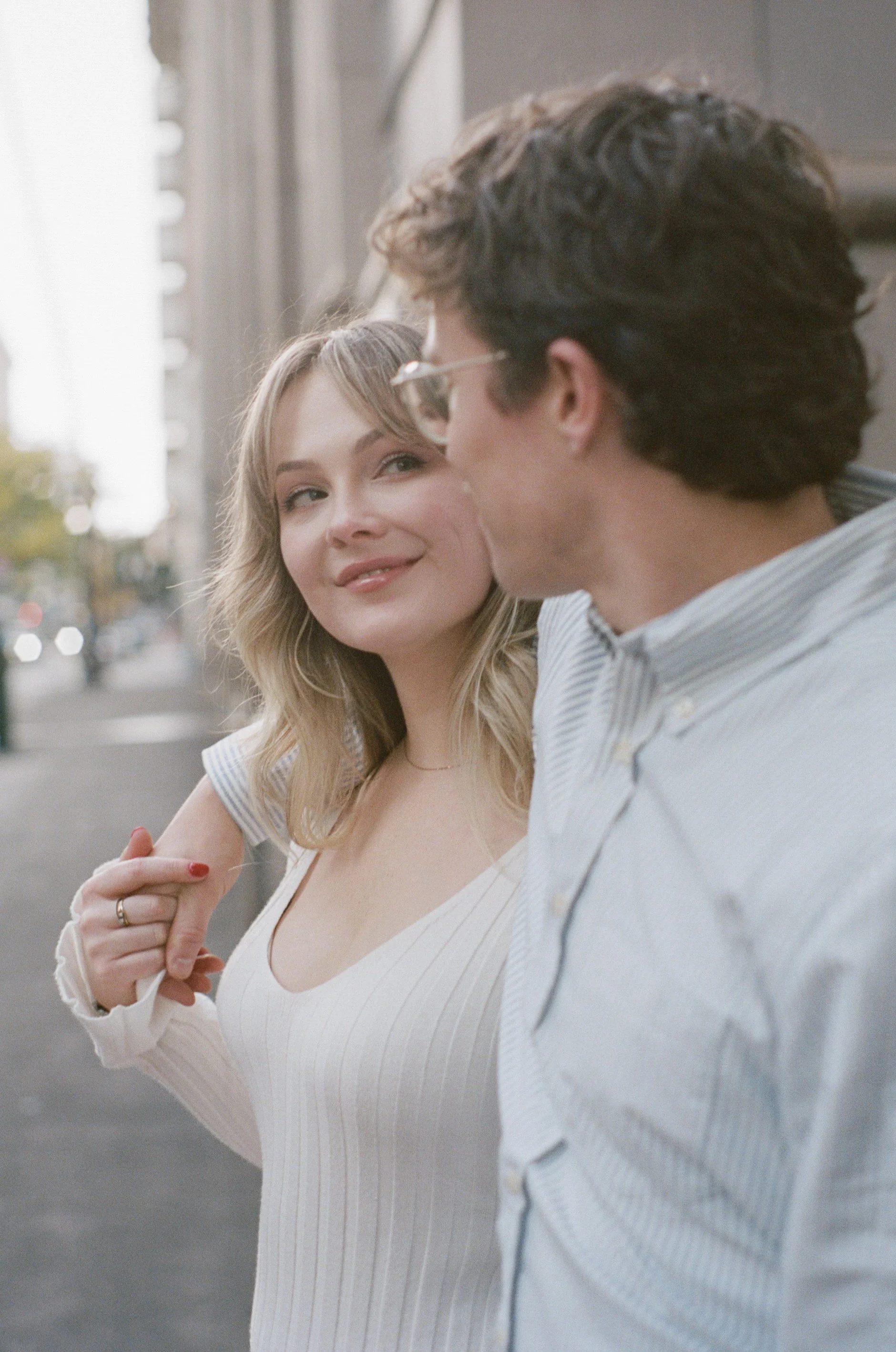  engagement photos outside Multnomah County Central Library Portland with fall leaves and soft movement, cinematic composition 