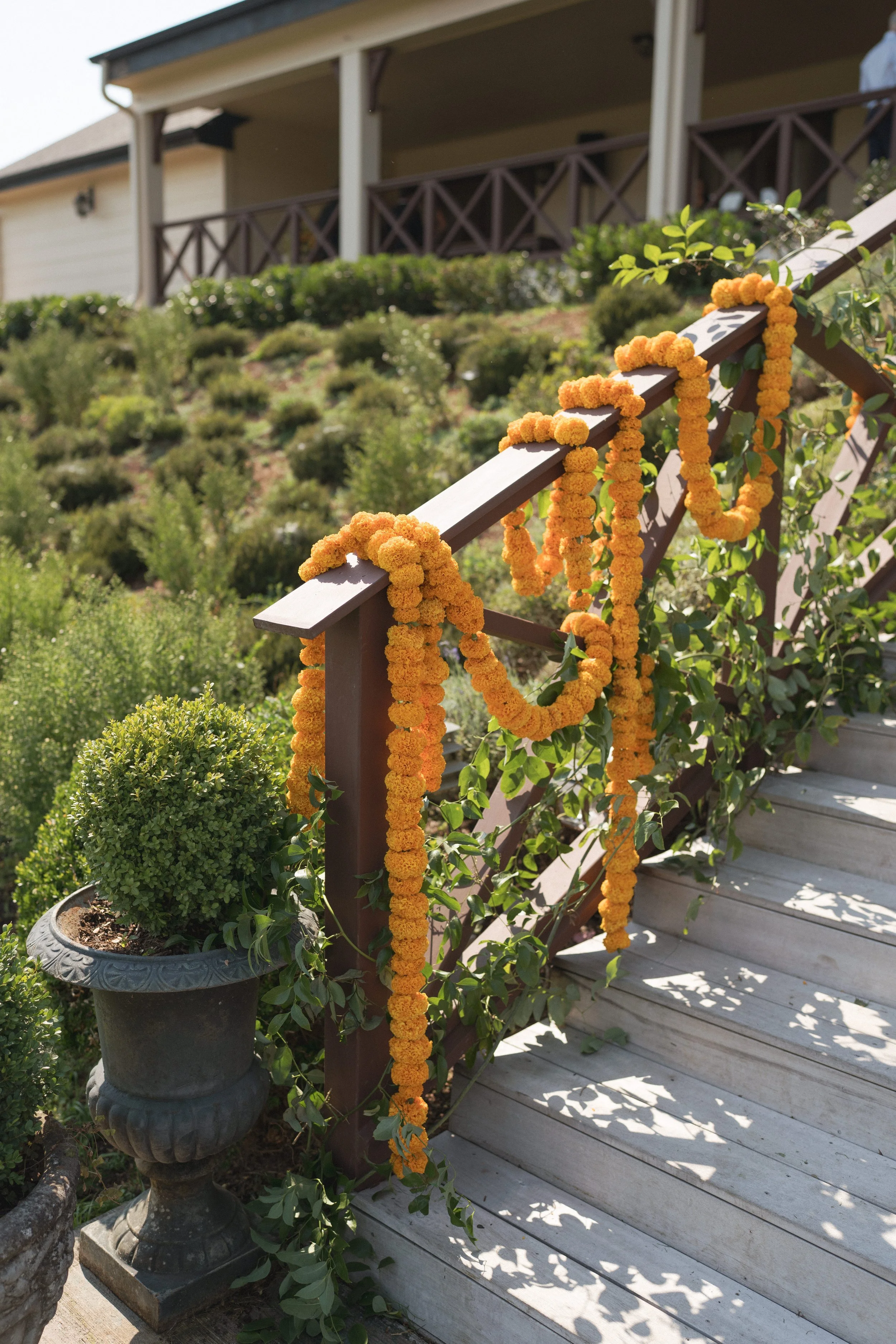  Vibrant orange and green wedding florals with abundant greenery and textured arrangements 