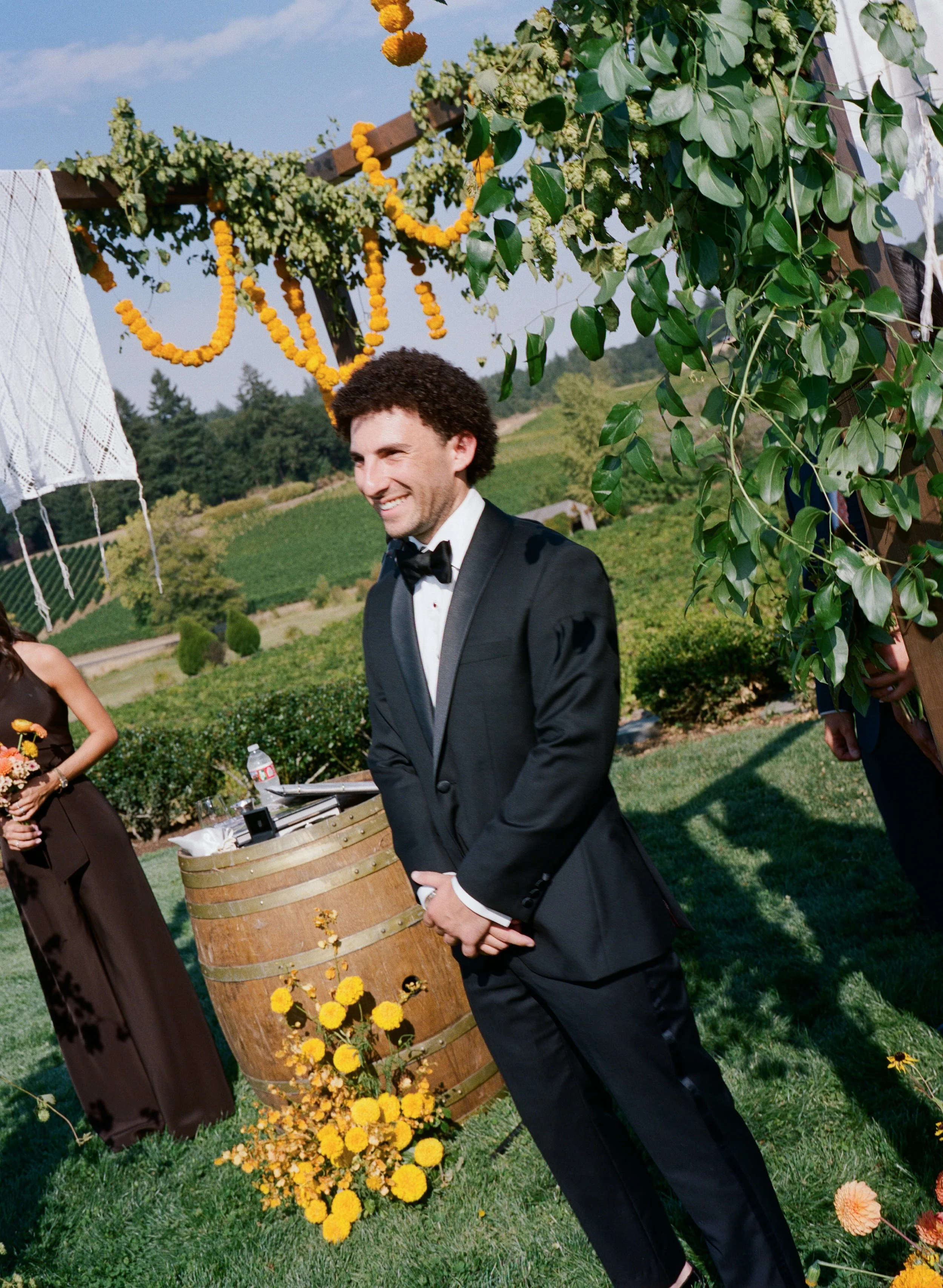  Film photograph of vibrant wedding florals with marigolds and greenery by Brier and Ivy 