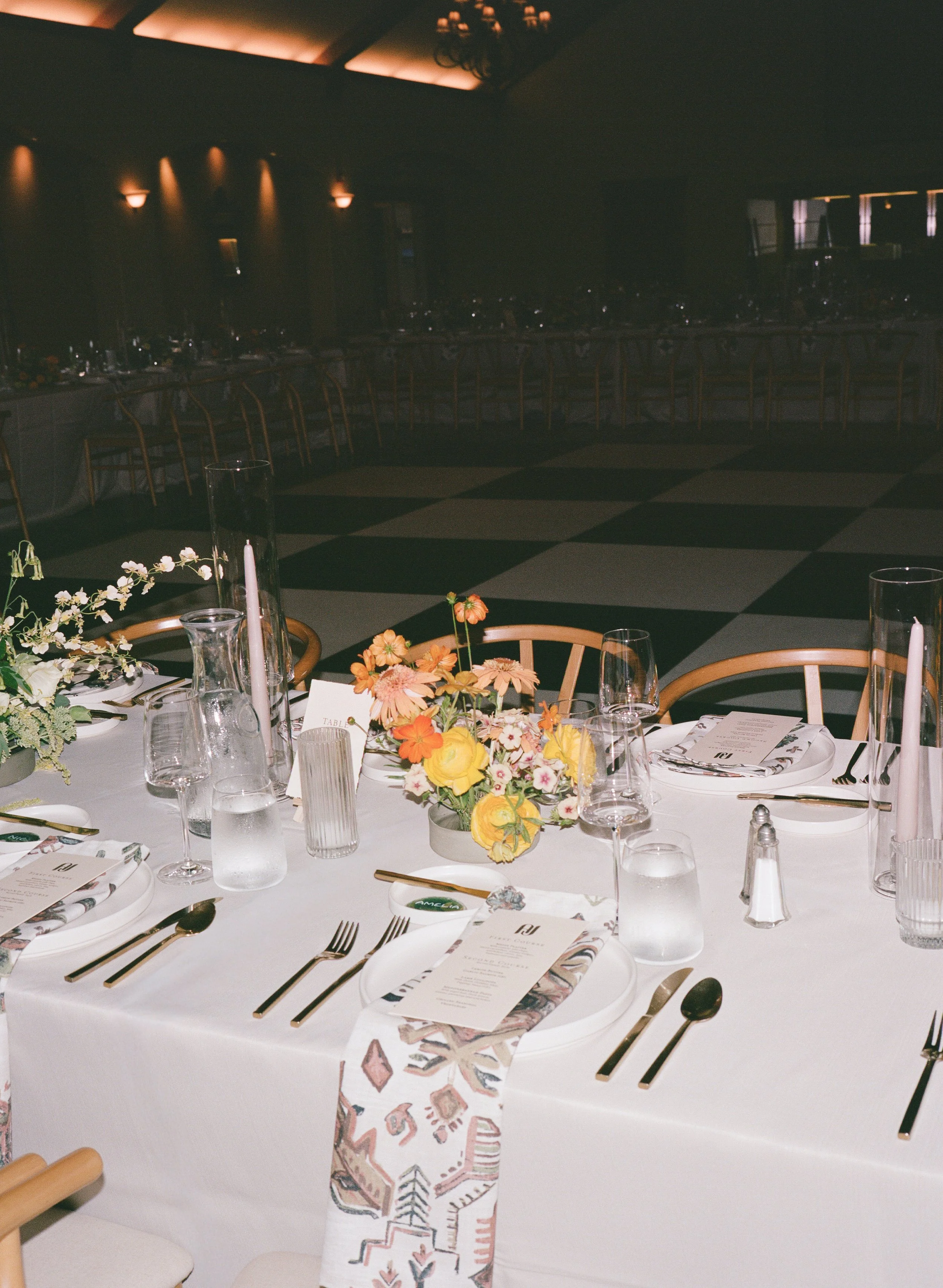  120mm film photo with direct flash of wedding reception dancing on black and white checkered dance floor 