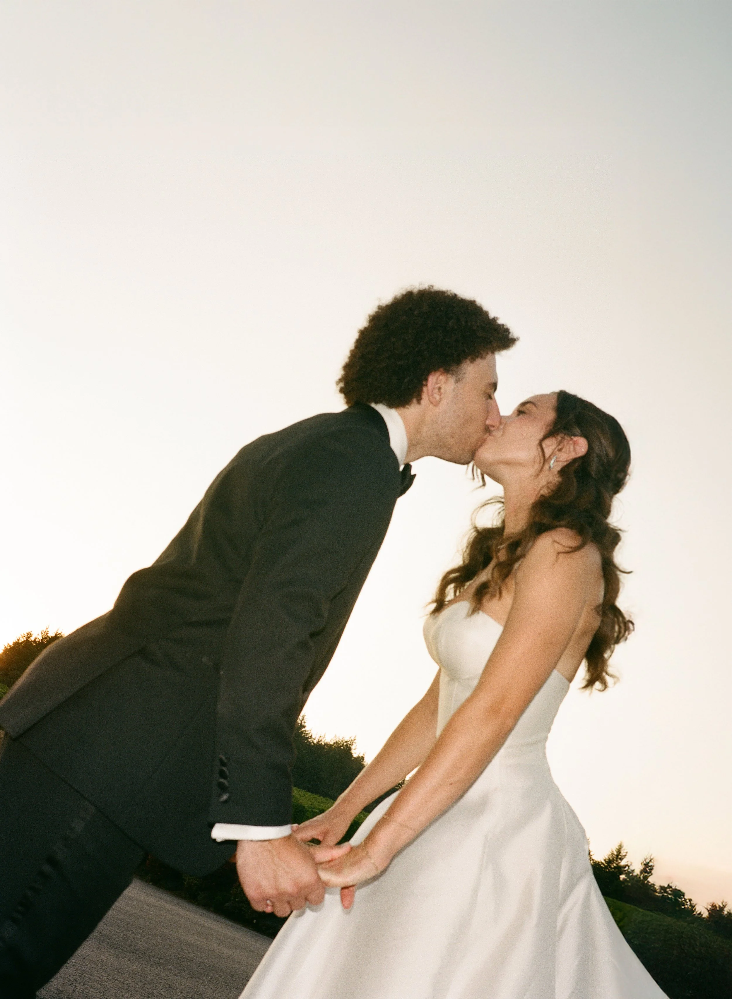  35mm film photo of romantic golden hour wedding portraits with soft light and natural movement 
