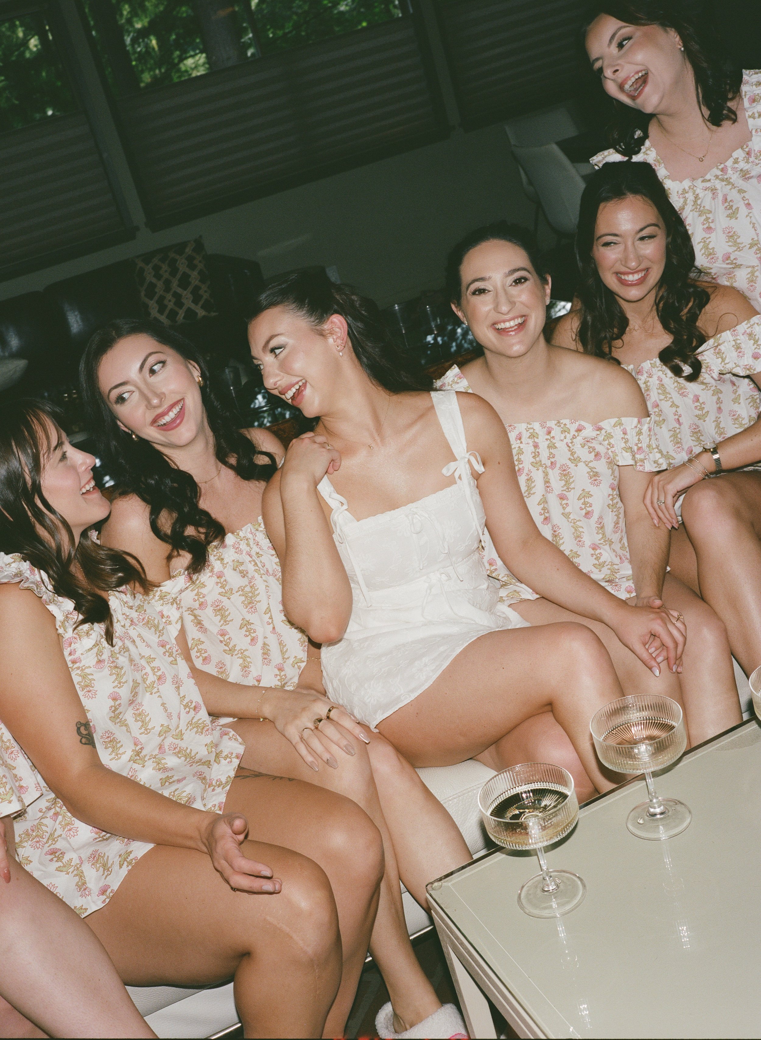  Garden-inspired wedding at JM Cellars featuring green and burgundy details, film photography, and an outdoor winery setting. Bride and bridesmaids getting ready. 
