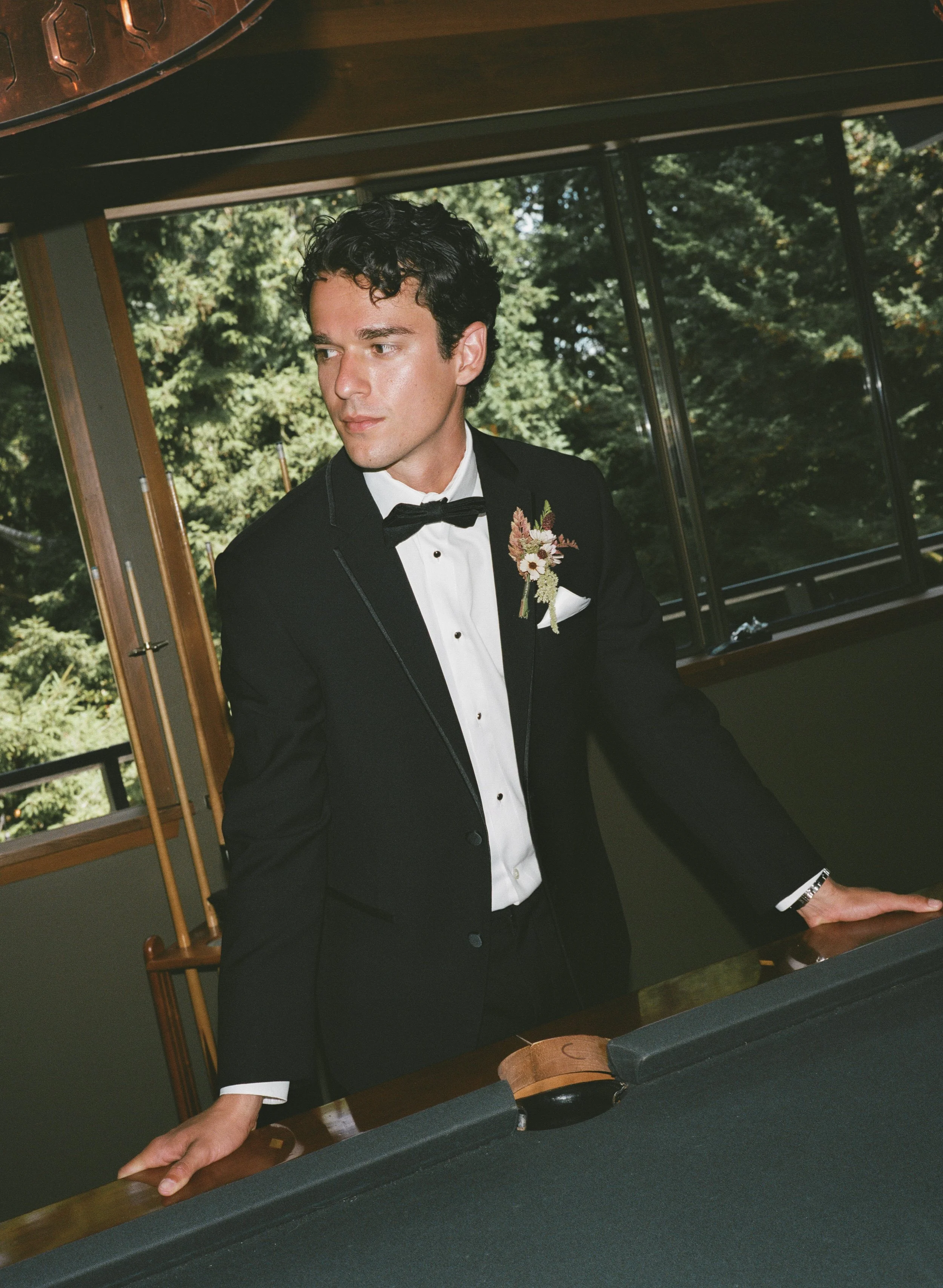  Groom portrait at JM Cellars winery surrounded by lush greenery and late summer foliage in Washington 