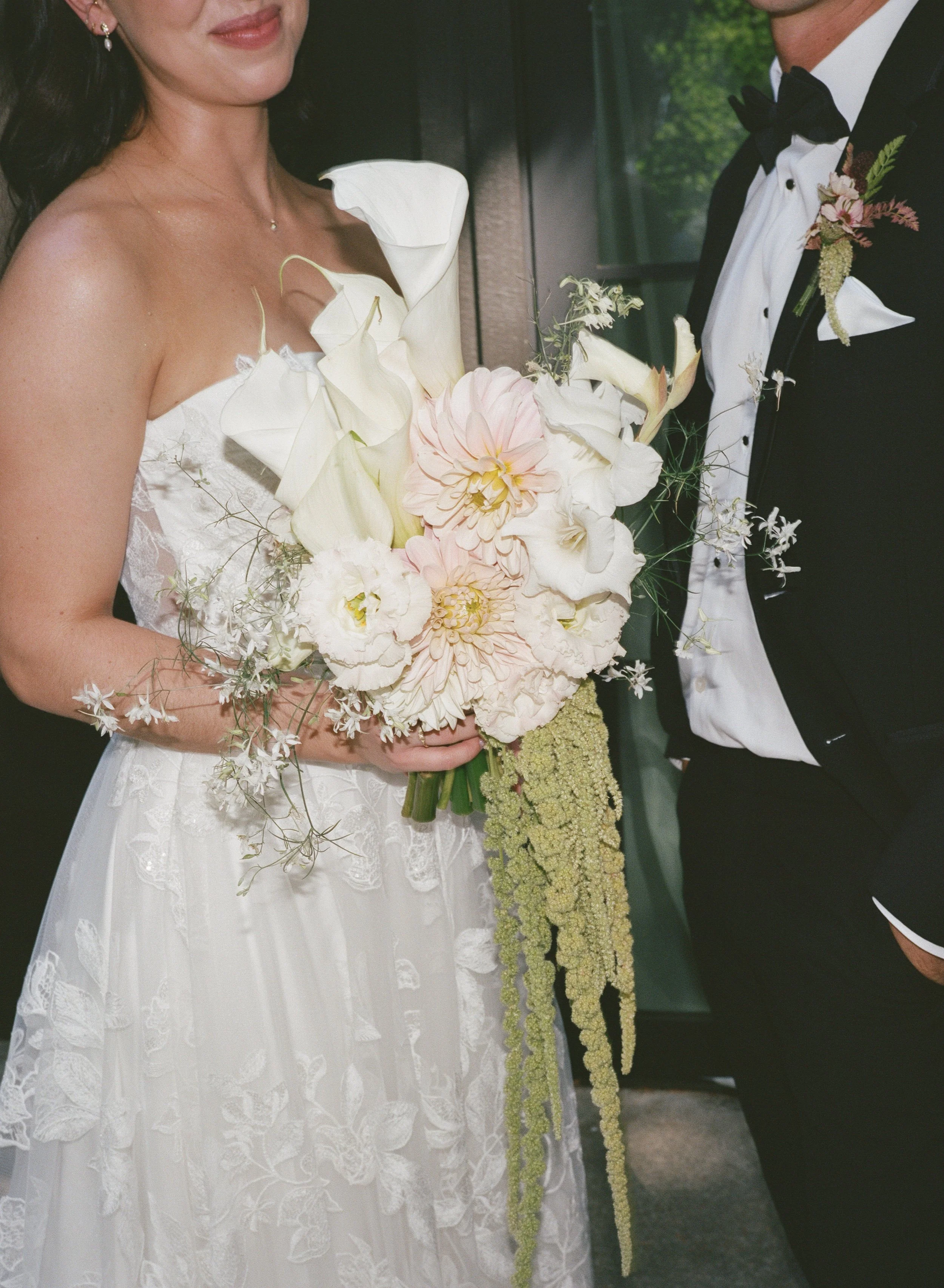  Bride and groom portrait at JM Cellars winery surrounded by lush greenery and late summer foliage in Washington 