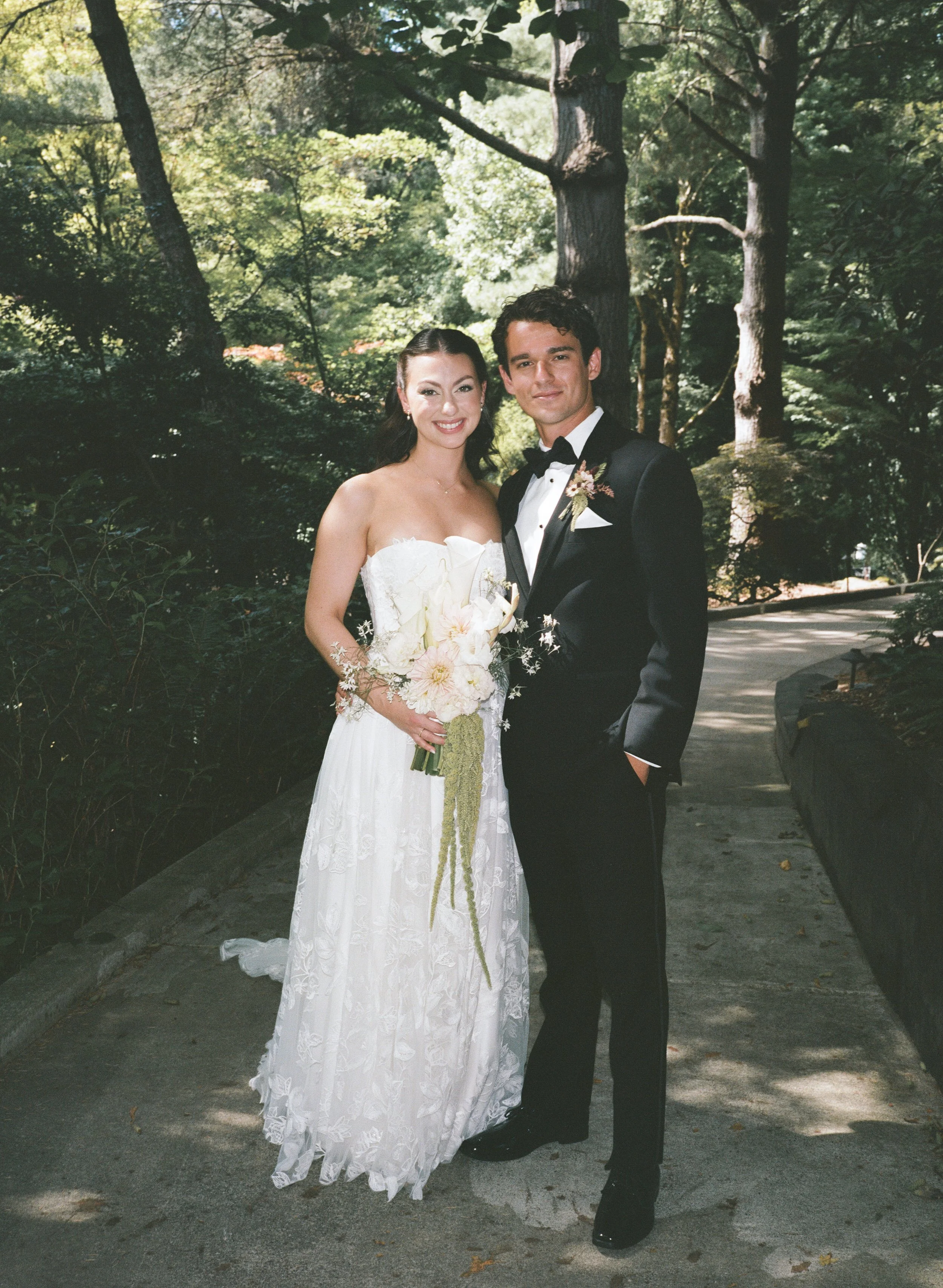  Bride and groom portrait at JM Cellars winery surrounded by lush greenery and late summer foliage in Washington 