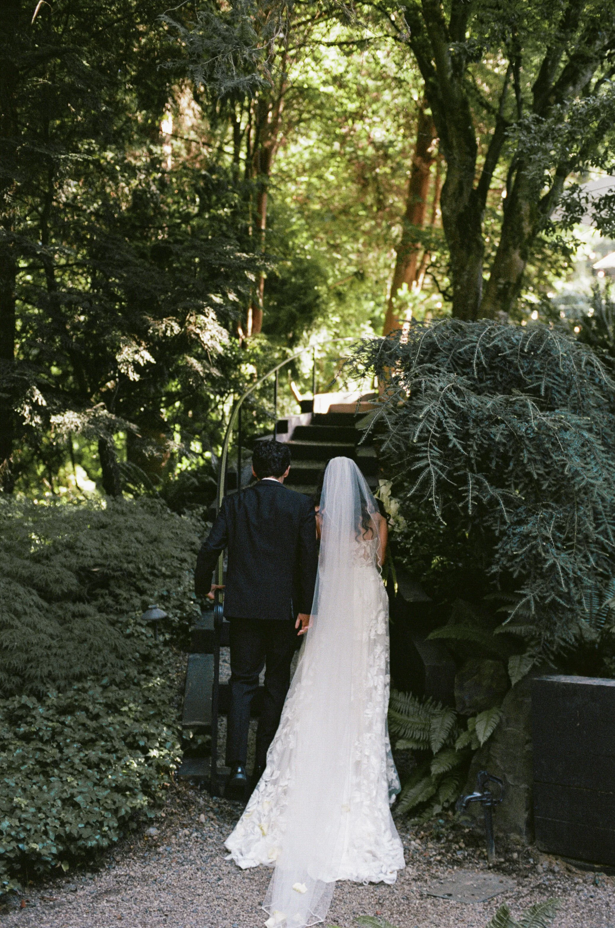  Bride and groom portrait at JM Cellars winery surrounded by lush greenery and late summer foliage in Washington 